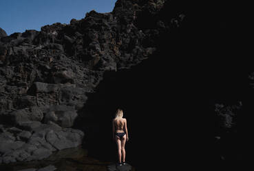 Rear View Of Woman Standing Against Rock Formation At Dusk - EYF01209