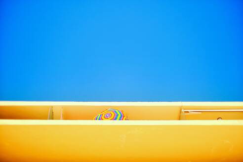 Low Angle View Of Balcony With Parasol Against Clear Blue Sky - EYF01264