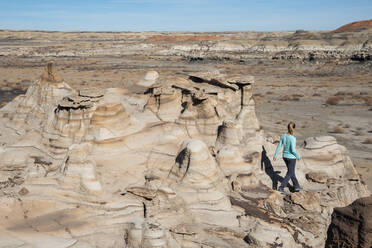 Hiking around hoodoo sandstone formations in Bisti/De-Na-Zin Wilderness, New Mexico, United States of America, North America - RHPLF14237