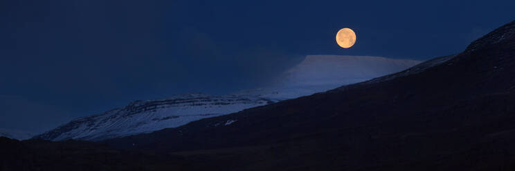Panorama of full moon above snow covered mountains, Iceland, Polar Regions - RHPLF14269