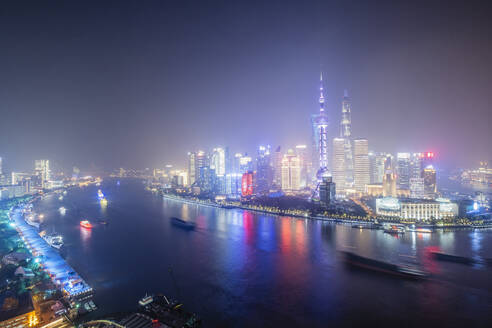 The illuminated skyline of Pudong district in Shanghai with the Huangpu River in the foreground, Shanghai, China, Asia - RHPLF14451