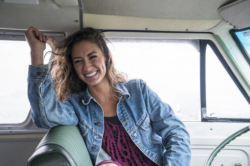Laughing teenage girl in front seat of vintage van - CAVF77251