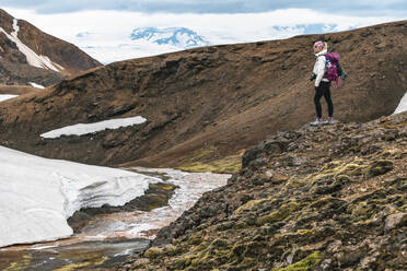 Female Hiker Standing Beside Glacial Melt - CAVF77331