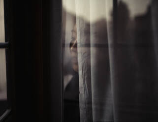 Close-Up Of Woman Looking Through Window - EYF01360