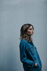 Thoughtful Woman Wearing Denim Jacket While Standing Outdoors - EYF01418