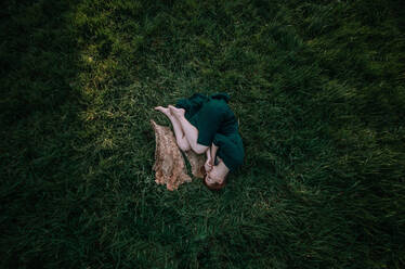 High Angle View of Woman Lying On Grass - EYF01504