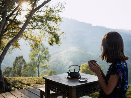Woman Drinking Tea In Garden - CAVF77427