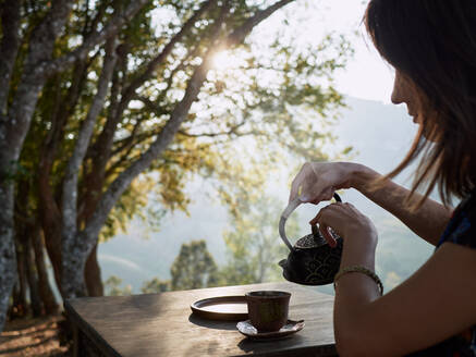 Woman Drinking Tea In Garden - CAVF77428