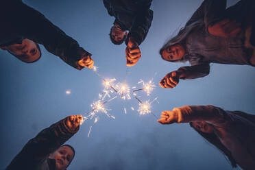 Five children holding sprklers against evening sky - OCMF01086