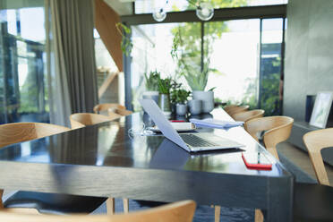 Working from home, laptop and smart phone on dining table - HOXF05303