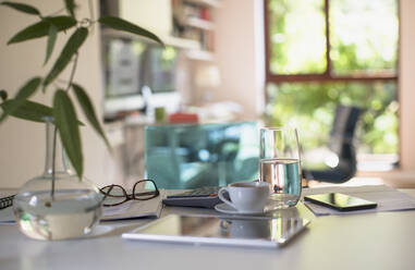 Digitales Tablet auf dem Tisch mit Kaffee und Taschenrechner - HOXF05322
