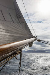 Sailboat mast over sunny ocean - HOXF05422