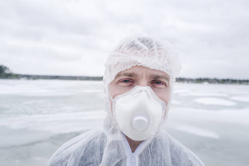 Portrait of man wearing protective suit and mask - EYAF00985