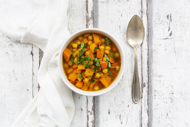 Bowl of oriental pumpkin stew with red kuri squash, roasted turmeric chick-peas and parsley - LVF08675