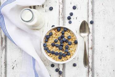 Milk bottle, napkin and bowl of muesli with blueberries - LVF08679