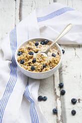 Napkin and bowl of muesli with blueberries - LVF08682