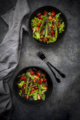 Two bowls of vegetarian salad with lettuce, strawberries and asparagus - LVF08684