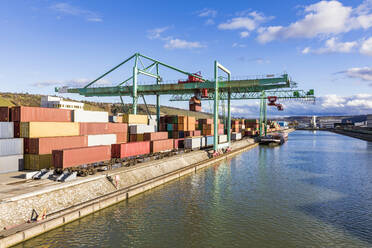 Germany, Baden-Wurttemberg, Stuttgart, Cargo containers stacked in commercial dock on bank of Neckar river - WDF05867