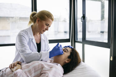 Woman receiving botox injection in medical practice - ABZF03006