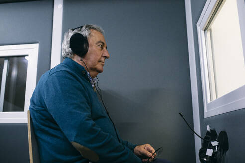 Patient with headphones during a hearing test - ABZF03036