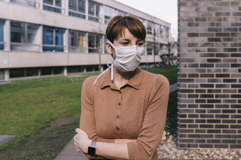 Portrait of woman wearing mask outdoors - MFF05160