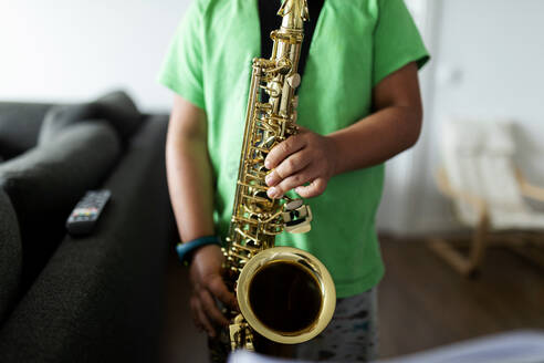 Junge übt zu Hause das Saxophonspielen - VABF02679