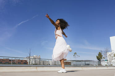 Happy young woman dancing - TCEF00322