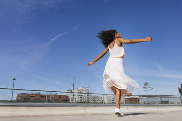 Happy young woman dancing - TCEF00323