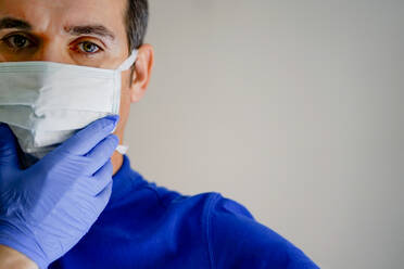 Doctor with face mask, using smartphone - CJMF00275