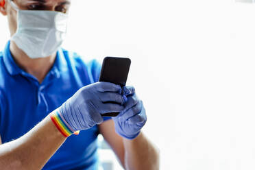 Doctor with face mask, using smartphone - CJMF00280