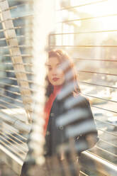 Beautiful woman standing in the sunlight - MEUF00300