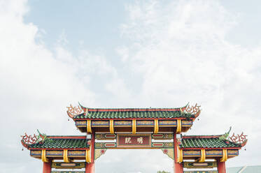 Malaysia, Low angle view of paifang gate standing against sky - JCMF00483