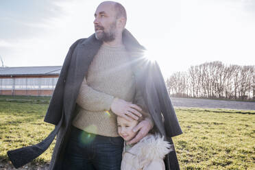 Father and little daughter on a field in winter - VYF00073