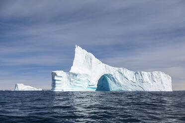 Majestätischer Eisbergbogen auf dem sonnigen blauen Atlantischen Ozean Grönlands - HOXF05759
