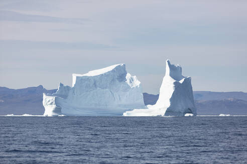 Majestätischer Eisberg auf dem sonnigen blauen Atlantischen Ozean Grönlands - HOXF05782