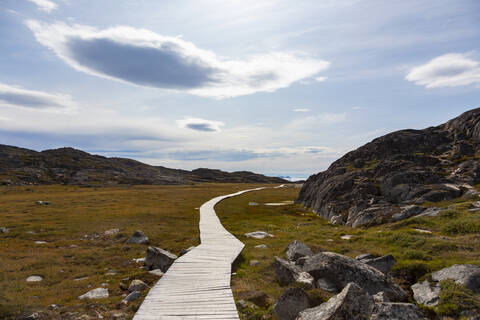 Wanderweg durch abgelegene, sonnige und zerklüftete Landschaft Grönlands, lizenzfreies Stockfoto