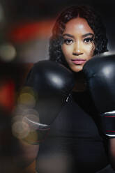 Port confident young woman in boxing gloves - HOXF05870