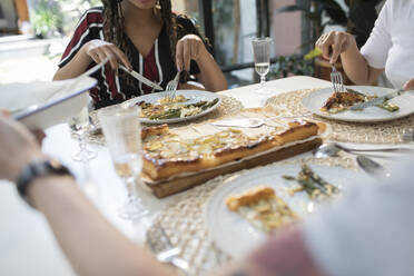 Women friends enjoying lunch at dining table - HOXF06118