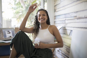 Portrait happy carefree young woman in home office - HOXF06126