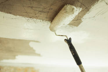 Paint roller painting ceiling white - HOXF06135