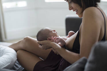 Mother holding and breastfeeding newborn baby son - HOXF06186
