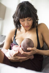 Mother breastfeeding newborn baby son - HOXF06196