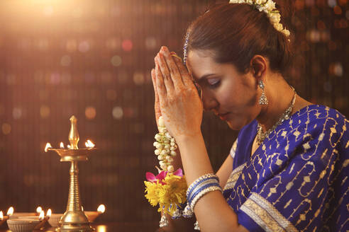 Beautiful Indian Woman In Sari Praying During Diwali - EYF01698