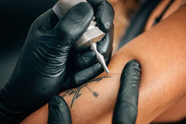 Cropped Image Of Person Tattooing On Hand - EYF01719