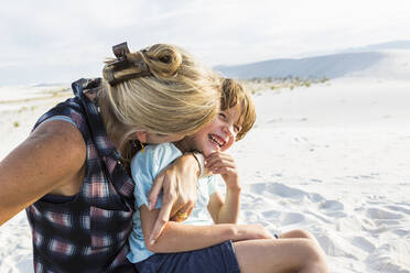 Mother and her six year old son embracing - MINF14307