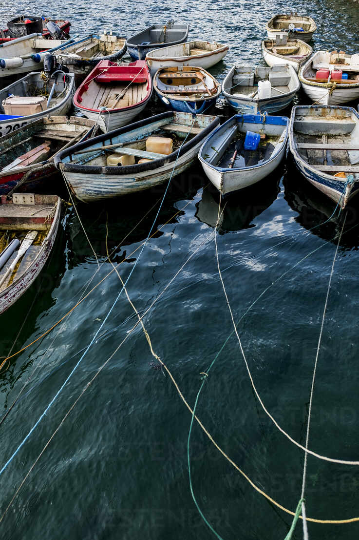 High angle view of colourful wooden fishing boats moored side by side in an  harbour. stock photo