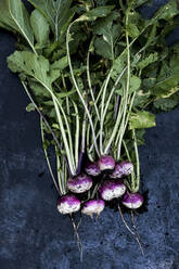 High angle close up of a bunch of freshly picked pink turnips on grey background. - MINF14423
