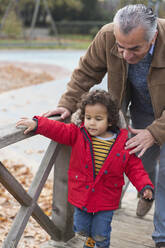 Grandfather walking with grandson - CAIF24528