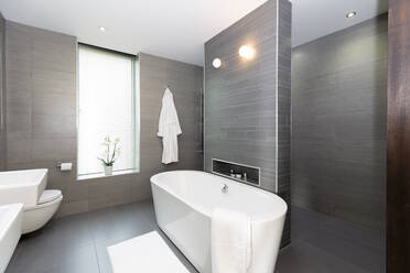 Modernes graues und weißes Badezimmer mit Badewanne - CAIF24683