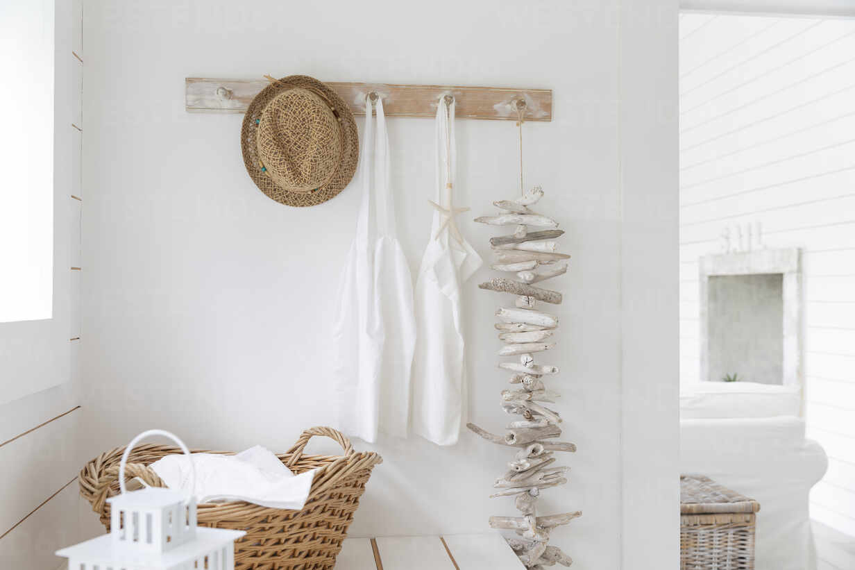 Driftwood and aprons hanging from beach house coat rack stock photo